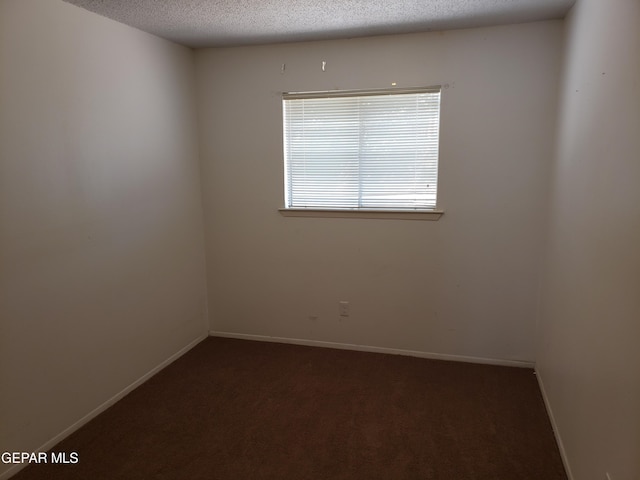10173 Lakeview Dr, El Paso, TX 79924 - unfurnished room featuring dark colored carpet, a textured ceiling, and baseboards
