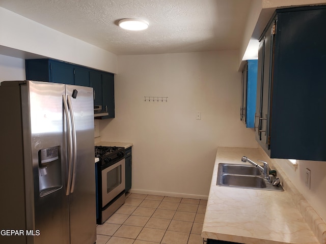 10173 Lakeview Dr, El Paso, TX 79924 - kitchen with stainless steel appliances, a sink, light countertops, a textured ceiling, and light tile patterned flooring