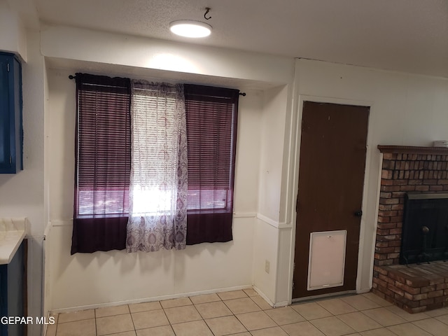 10173 Lakeview Dr, El Paso, TX 79924 - interior space featuring light tile patterned floors, a fireplace, and baseboards