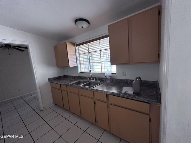 5403 Raymond Telles Rd, El Paso, TX 79924 - kitchen with a sink, dark countertops, light tile patterned floors, and cream cabinets