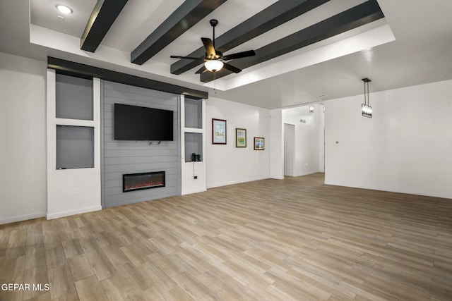 7467 Cimarron Gap Dr, El Paso, TX 79911 - unfurnished living room featuring ceiling fan, beamed ceiling, a large fireplace, light wood finished floors, and baseboards