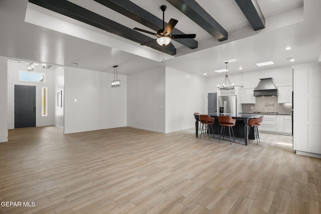 7467 Cimarron Gap Dr, El Paso, TX 79911 - living area with beamed ceiling, light wood-style floors, a ceiling fan, recessed lighting, and baseboards
