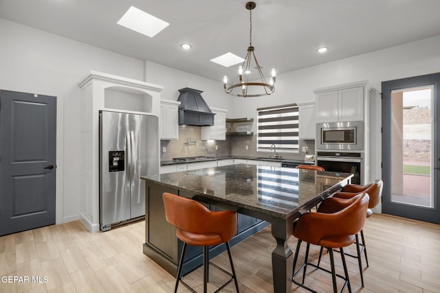 7467 Cimarron Gap Dr, El Paso, TX 79911 - kitchen with appliances with stainless steel finishes, a sink, open shelves, a chandelier, and a skylight