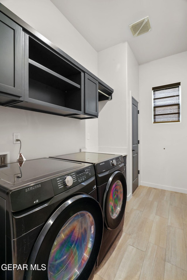 7467 Cimarron Gap Dr, El Paso, TX 79911 - washroom featuring cabinet space, separate washer and dryer, light wood-type flooring, and baseboards