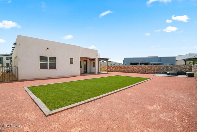 7467 Cimarron Gap Dr, El Paso, TX 79911 - back of house with stucco siding and a patio