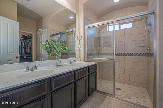 2221 Furtherpoint Pl, El Paso, TX 79911 - bathroom featuring a stall shower, double vanity, and a walk in closet