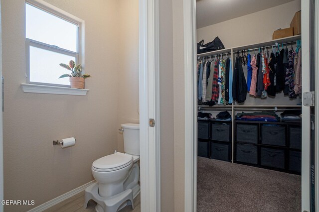 2221 Furtherpoint Pl, El Paso, TX 79911 - bathroom featuring toilet, baseboards, and a walk in closet