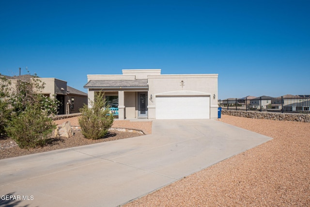 2221 Furtherpoint Pl, El Paso, TX 79911 - view of front facade with a garage, driveway, stucco siding, a tiled roof, and covered porch