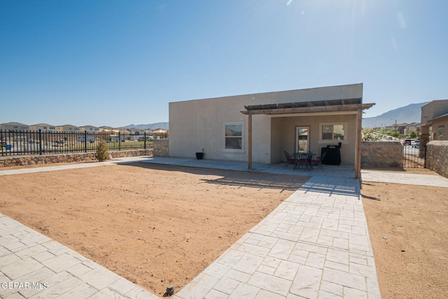 2221 Furtherpoint Pl, El Paso, TX 79911 - back of property featuring a patio area, a mountain view, a fenced backyard, and stucco siding