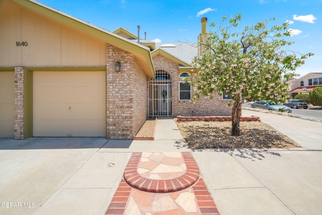 1640 Dennis Babjack Dr, El Paso, TX 79936 - view of front of home with concrete driveway, brick siding, and an attached garage