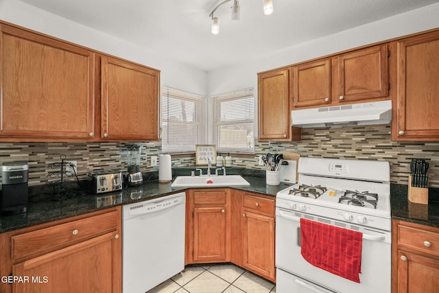 1640 Dennis Babjack Dr, El Paso, TX 79936 - kitchen featuring white appliances, under cabinet range hood, a sink, light tile patterned flooring, and backsplash