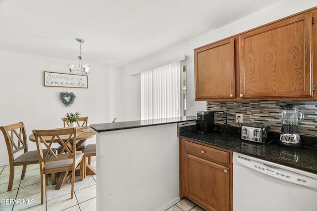 1640 Dennis Babjack Dr, El Paso, TX 79936 - kitchen with white dishwasher, backsplash, light tile patterned floors, a peninsula, and brown cabinetry