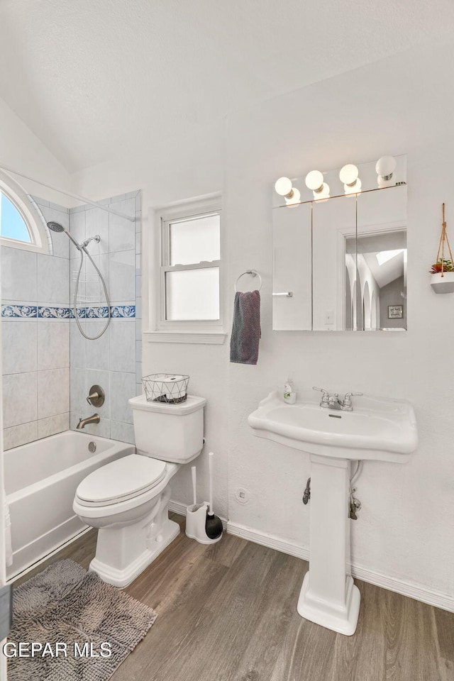 1640 Dennis Babjack Dr, El Paso, TX 79936 - bathroom with wood finished floors, baseboards,  shower combination, toilet, and vaulted ceiling