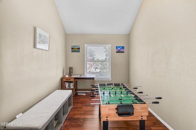 1640 Dennis Babjack Dr, El Paso, TX 79936 - recreation room featuring wood finished floors, baseboards, a textured wall, and vaulted ceiling
