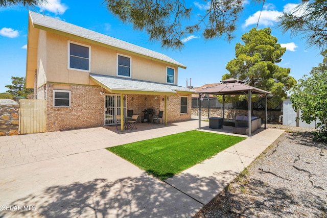 1640 Dennis Babjack Dr, El Paso, TX 79936 - rear view of property featuring a gazebo, an outdoor hangout area, stucco siding, and a patio
