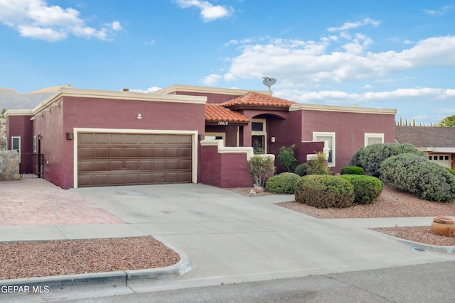 10819 Loma De Amor Ln, El Paso, TX 79934 - view of front of property featuring stucco siding, concrete driveway, an attached garage, and a tile roof