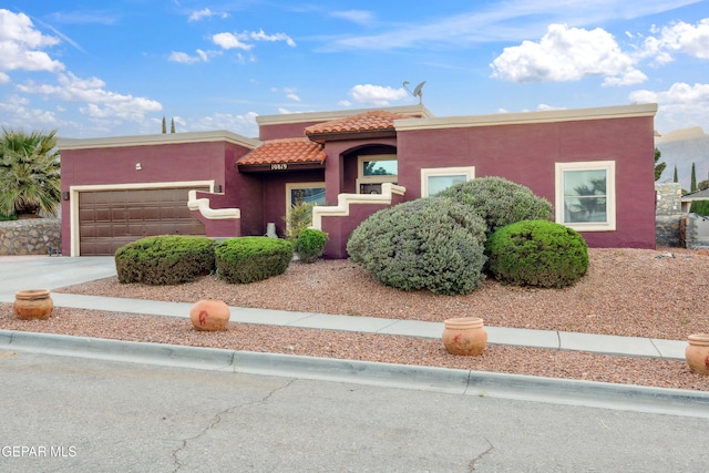 10819 Loma De Amor Ln, El Paso, TX 79934 - view of front of home featuring a tile roof, an attached garage, stucco siding, and concrete driveway
