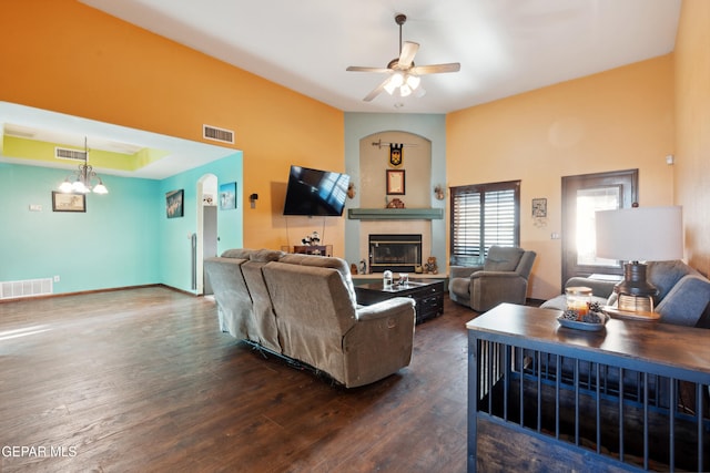 10819 Loma De Amor Ln, El Paso, TX 79934 - living room featuring a glass covered fireplace, dark wood-style flooring, a chandelier, a ceiling fan, and baseboards