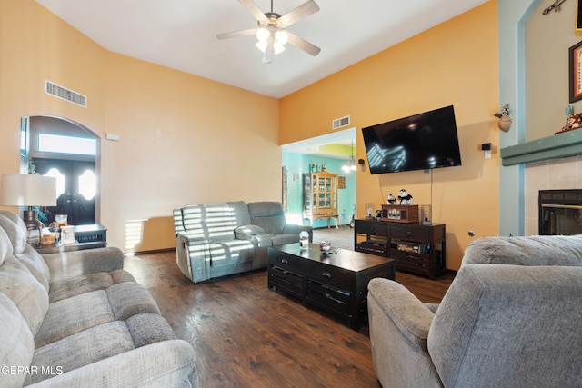 10819 Loma De Amor Ln, El Paso, TX 79934 - living room featuring a ceiling fan, a towering ceiling, wood finished floors, and a tiled fireplace