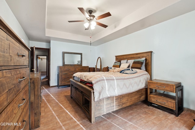 10819 Loma De Amor Ln, El Paso, TX 79934 - bedroom with a raised ceiling, baseboards, a ceiling fan, and light wood-style floors
