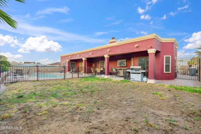 10819 Loma De Amor Ln, El Paso, TX 79934 - back of house featuring a patio, a chimney, and stucco siding