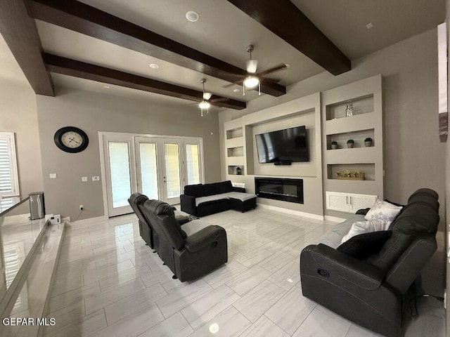 14529 Tierra Spring Ave, El Paso, TX 79938 - living room featuring beamed ceiling, a ceiling fan, built in shelves, a glass covered fireplace, and baseboards