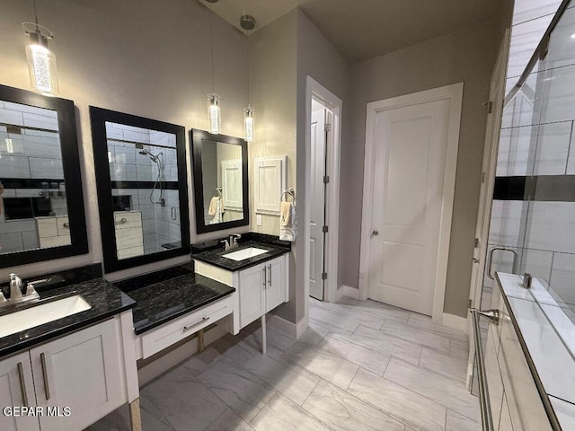 14529 Tierra Spring Ave, El Paso, TX 79938 - full bathroom with marble look tiles, a stall shower, two vanities, and baseboards