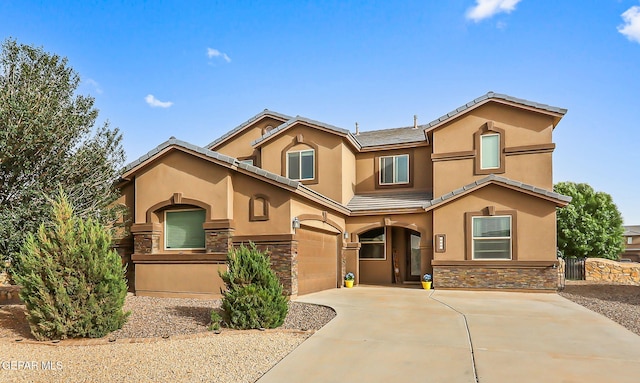 5505 Valley Cedar Dr, El Paso, TX 79932 - view of front facade with stucco siding, stone siding, a garage, and driveway
