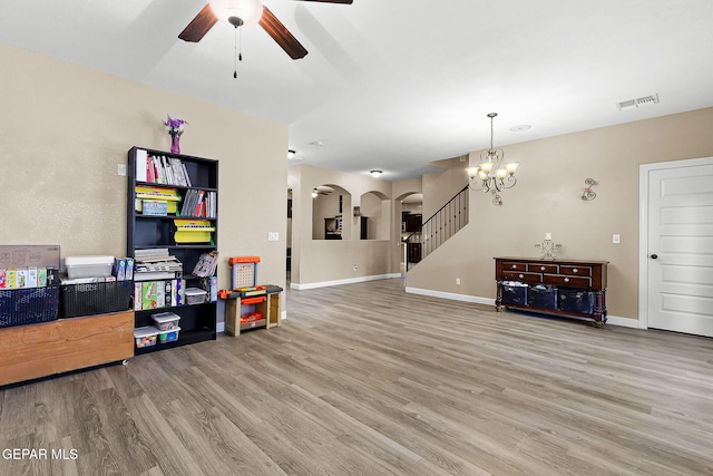 5505 Valley Cedar Dr, El Paso, TX 79932 - living room featuring arched walkways, a ceiling fan, light wood finished floors, and a chandelier