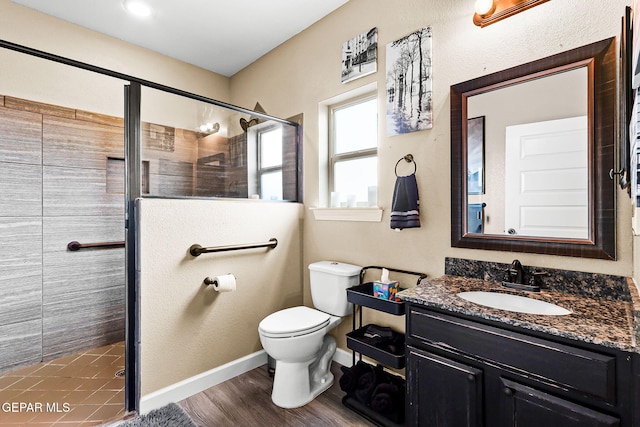 5505 Valley Cedar Dr, El Paso, TX 79932 - bathroom featuring toilet, a shower stall, vanity, and baseboards