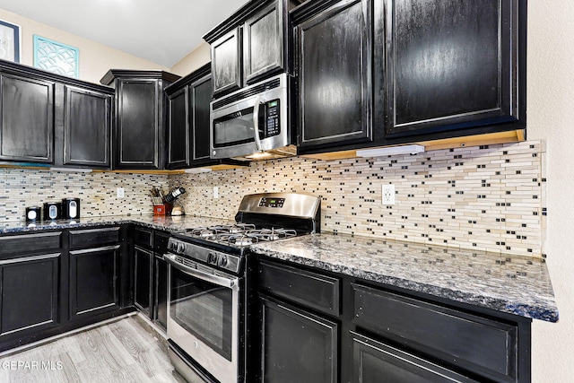 5505 Valley Cedar Dr, El Paso, TX 79932 - kitchen featuring appliances with stainless steel finishes, dark cabinets, and dark stone countertops