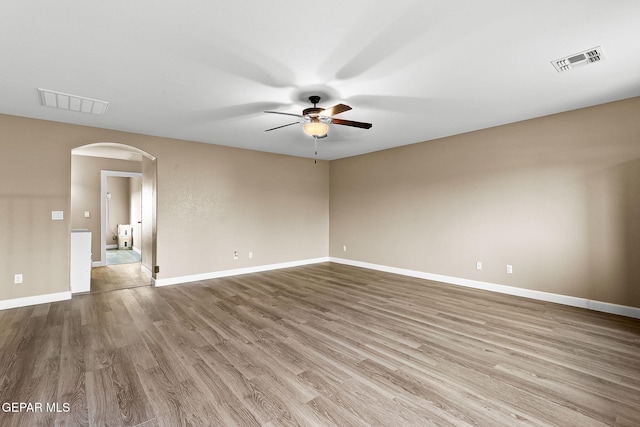 5505 Valley Cedar Dr, El Paso, TX 79932 - unfurnished room with a ceiling fan, arched walkways, wood finished floors, and baseboards