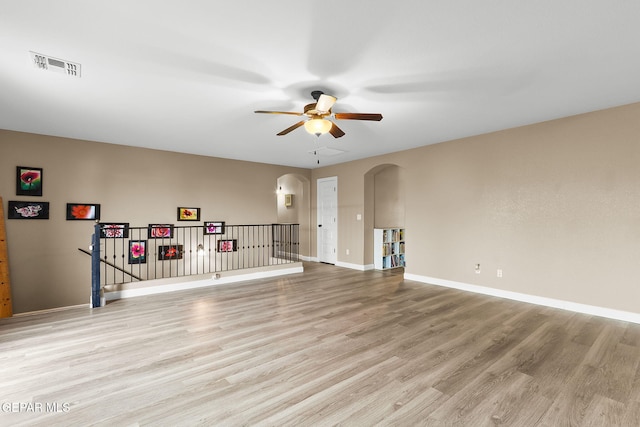 5505 Valley Cedar Dr, El Paso, TX 79932 - spare room with arched walkways, ceiling fan, light wood finished floors, and baseboards