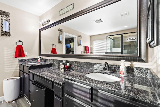 5505 Valley Cedar Dr, El Paso, TX 79932 - full bath with double vanity, wood finished floors, and a shower