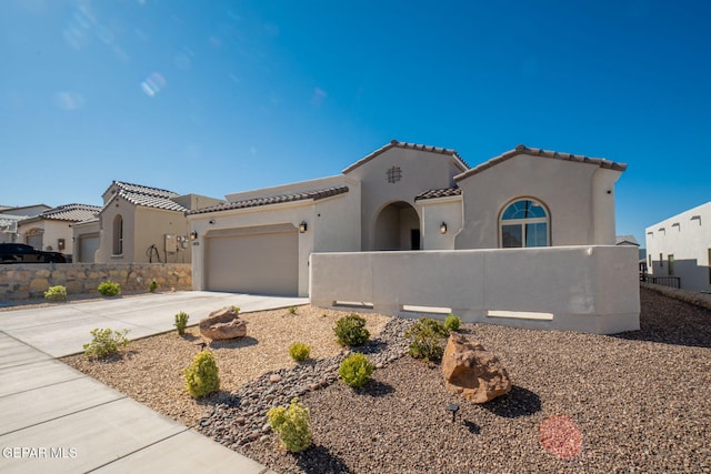 13436 Emerald Crystal Dr, El Paso, TX 79928 - mediterranean / spanish home with a fenced front yard, concrete driveway, a tiled roof, and stucco siding