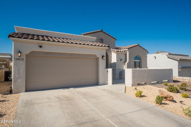 13436 Emerald Crystal Dr, El Paso, TX 79928 - mediterranean / spanish-style house with driveway, a garage, stucco siding, and a tile roof