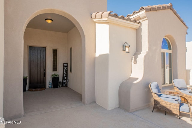 13436 Emerald Crystal Dr, El Paso, TX 79928 - doorway to property with stucco siding, a patio, and a tile roof