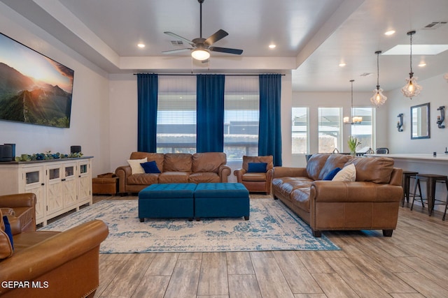 13436 Emerald Crystal Dr, El Paso, TX 79928 - living area featuring a ceiling fan, a chandelier, wood finished floors, a tray ceiling, and recessed lighting