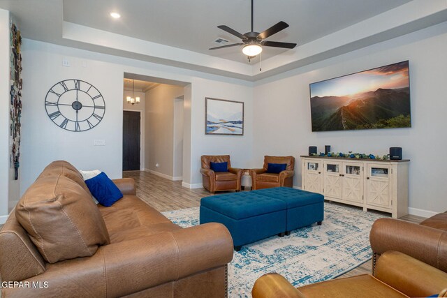 13436 Emerald Crystal Dr, El Paso, TX 79928 - living room featuring a tray ceiling, baseboards, a ceiling fan, wood finished floors, and recessed lighting
