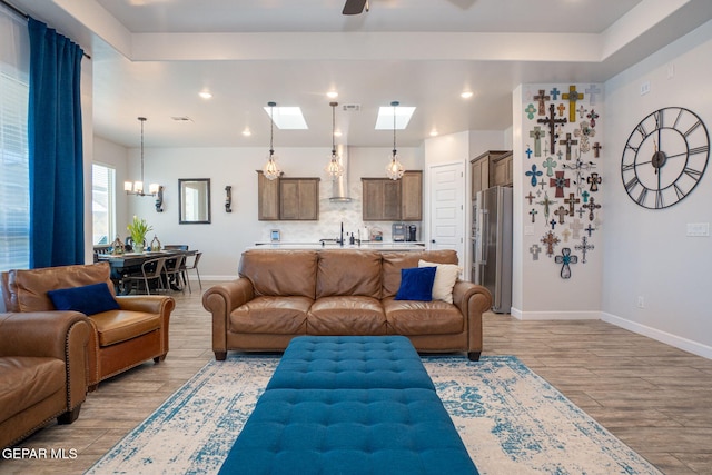 13436 Emerald Crystal Dr, El Paso, TX 79928 - living room featuring wood finished floors, baseboards, a chandelier, ceiling fan, and recessed lighting