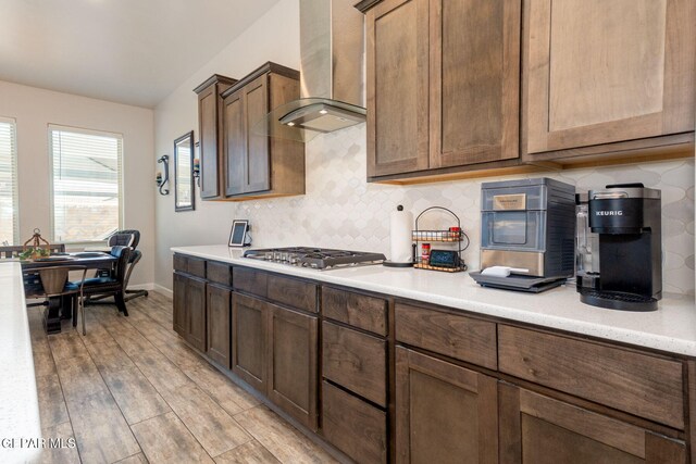 13436 Emerald Crystal Dr, El Paso, TX 79928 - kitchen with wall chimney exhaust hood, stainless steel gas cooktop, decorative backsplash, and light countertops