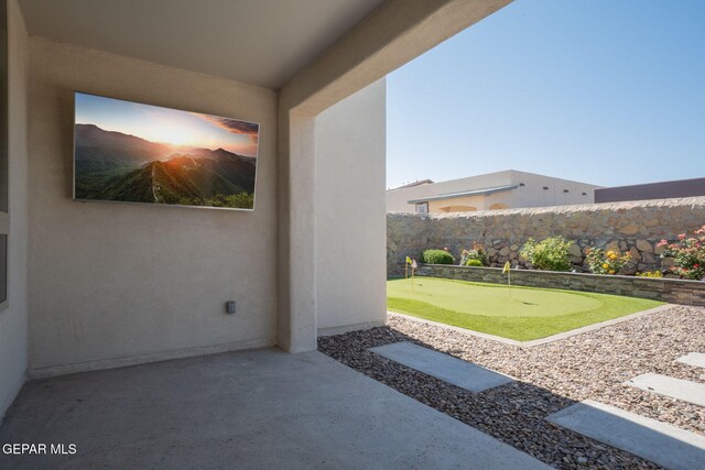 13436 Emerald Crystal Dr, El Paso, TX 79928 - fenced backyard featuring an area to practice putting and a patio