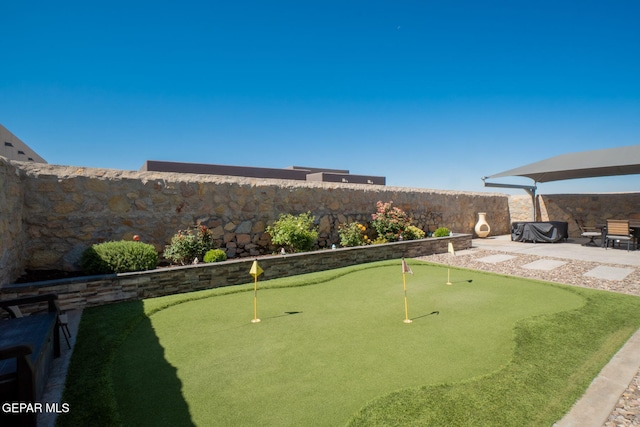13436 Emerald Crystal Dr, El Paso, TX 79928 - fenced backyard featuring an area to practice putting and a patio area