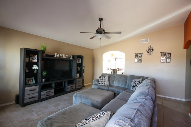 14244 Trigger Rock Ln, El Paso, TX 79938 - living room with light tile patterned floors, baseboards, lofted ceiling, ceiling fan, and arched walkways