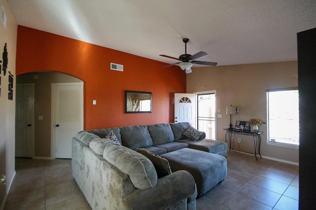 14244 Trigger Rock Ln, El Paso, TX 79938 - living room featuring a ceiling fan, tile patterned flooring, lofted ceiling, baseboards, and arched walkways