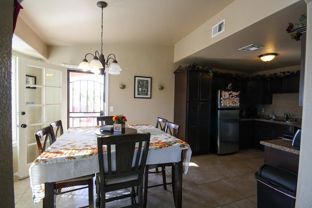 14244 Trigger Rock Ln, El Paso, TX 79938 - dining area with light tile patterned flooring and a chandelier