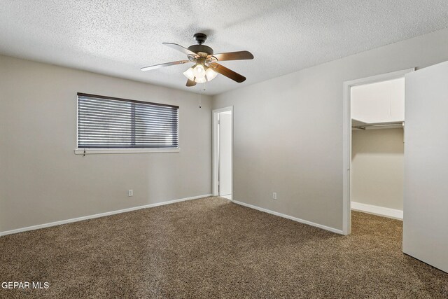 10224 Galahad Way, El Paso, TX 79924 - unfurnished bedroom featuring carpet floors, a spacious closet, a textured ceiling, ceiling fan, and a closet