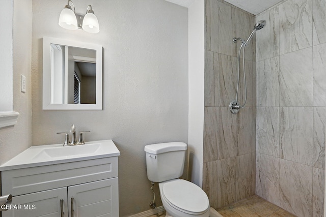 10224 Galahad Way, El Paso, TX 79924 - bathroom featuring toilet, a tile shower, and vanity