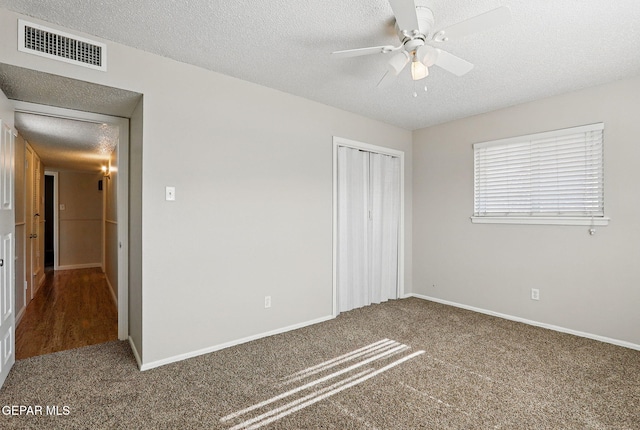 10224 Galahad Way, El Paso, TX 79924 - unfurnished bedroom featuring a textured ceiling, carpet floors, a closet, and baseboards