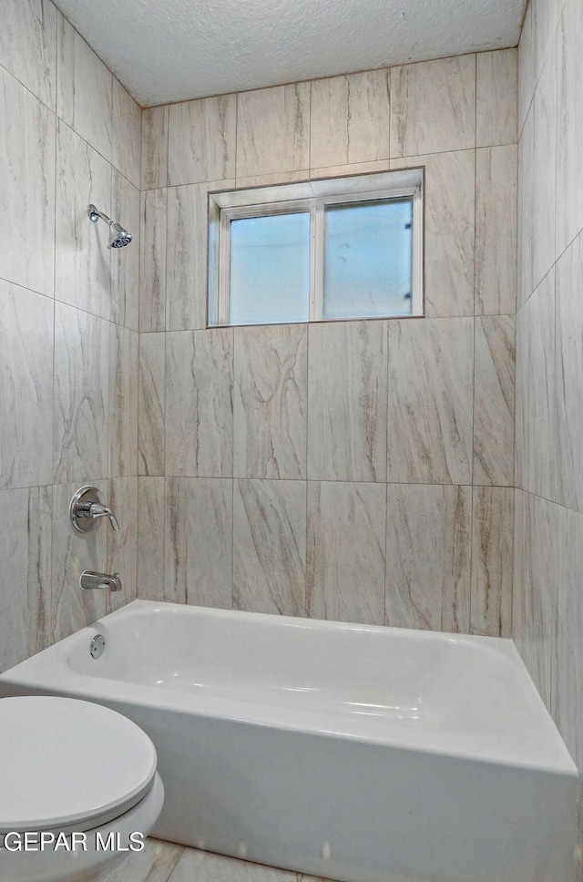 10224 Galahad Way, El Paso, TX 79924 - full bathroom featuring toilet, bathing tub / shower combination, and a textured ceiling